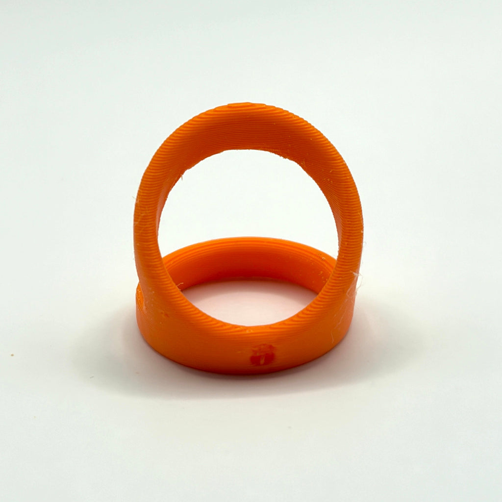 An orange 3D-printed ring shown on a neutral gray background.