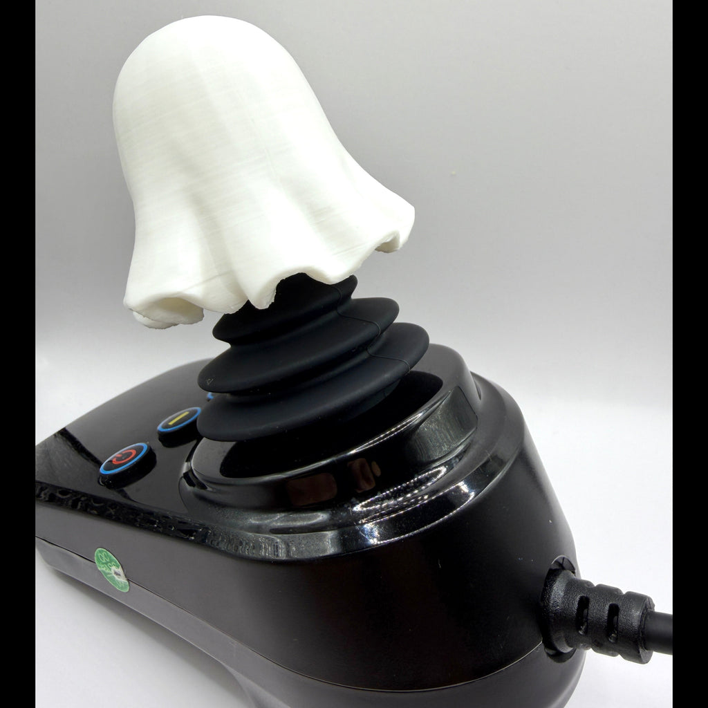 A novelty ghost-shaped joystick with a white ghost head and black stalk, mounted on a glossy black base with buttons and a power cord, shown against a light gray background.
