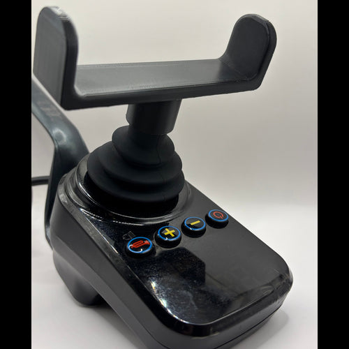 A black plastic joystick control module with a mounting bracket on top and four blue-rimmed buttons on the front face, photographed against a plain light background.