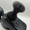 A black joystick control with a textured mushroom shaped grip and four blue buttons featuring red, yellow, and green symbols, shown on a white background.